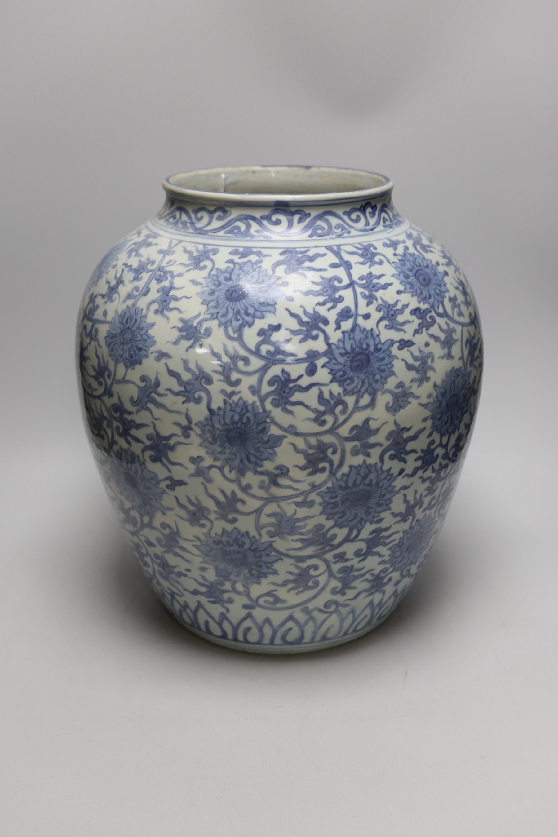 A Chinese blue and white 'lotus' jar, 17th century, 38cms high, restored
